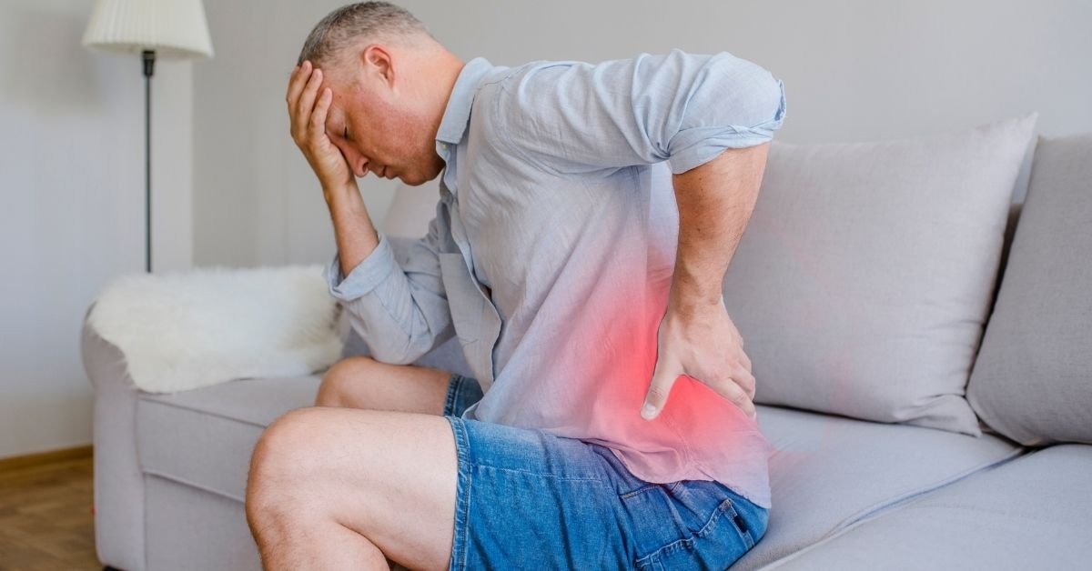 man-holding-lower-back-in-pain-before-visiting-a-chiropractor