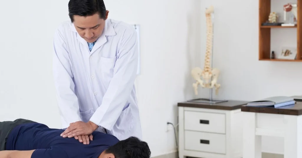 chiropractor-performing-manual-spinal-adjustment-in-a-clinical-setting-with-spine-model-in-background
