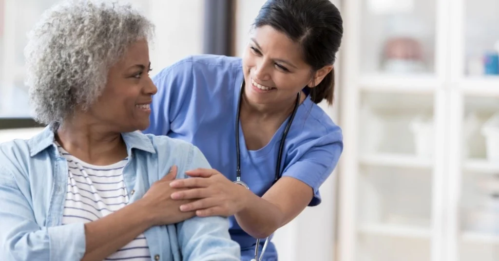 smiling-chiropractor-comforting-a-patient-during-a-spinal-care-consultation