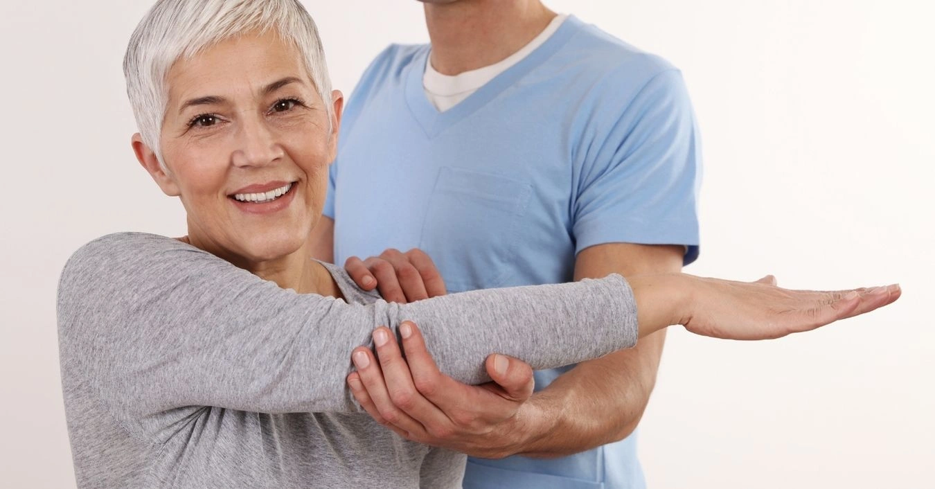 chiropractor-assisting-an-older-woman-during-a-therapy-session-for-back-pain-relief